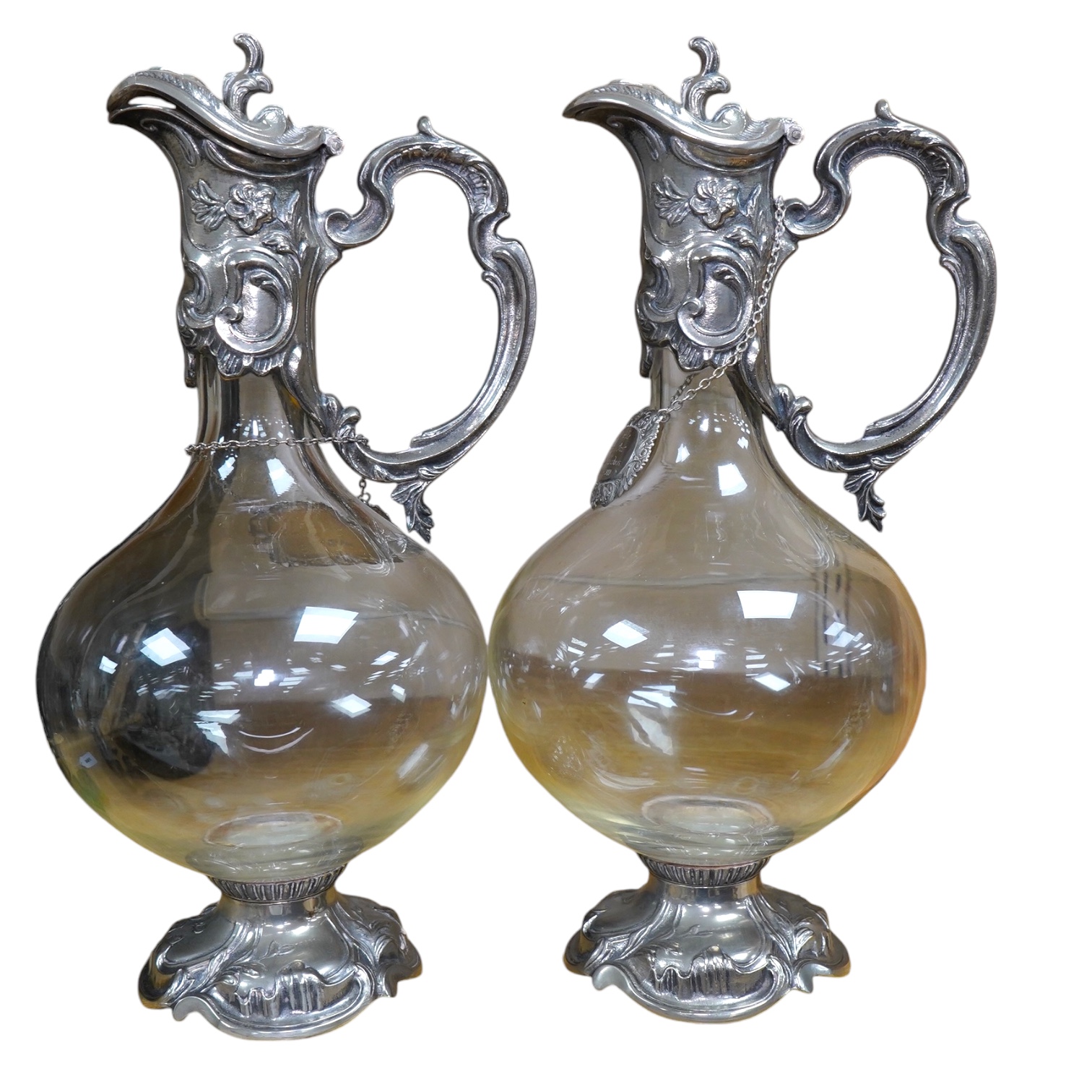 A pair of Art Nouveau silver plate mounted claret jugs with labels, 32cm. Condition - fair to good